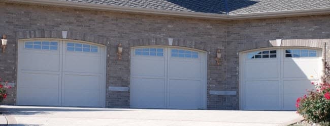 Technician repairing a garage door in Granbury, Texas